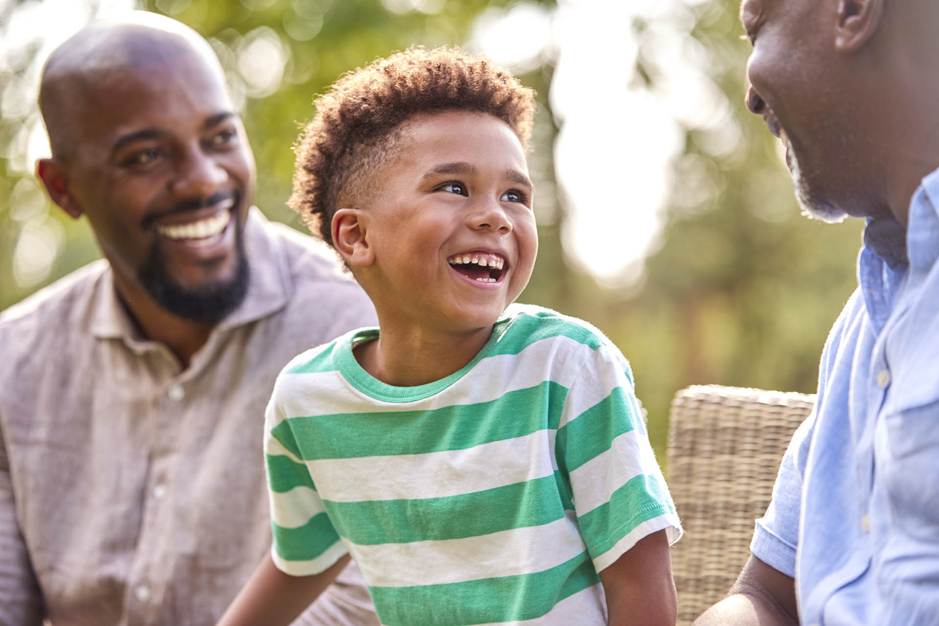 Smiling Multi-Generation Male Family At Home In Garden Together